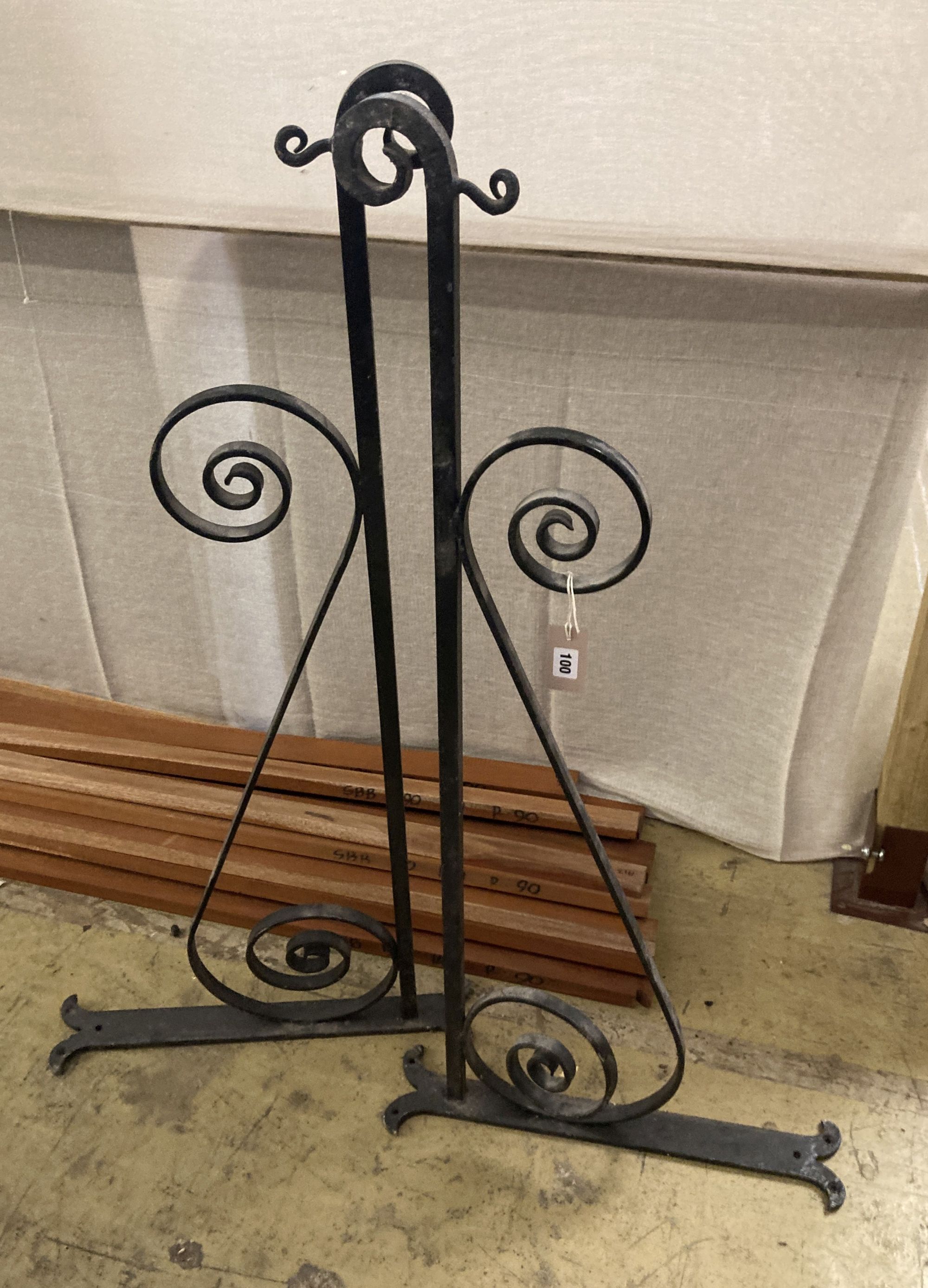 A pair of black painted wrought iron wall mounting brackets, width 114cm, height 54cm